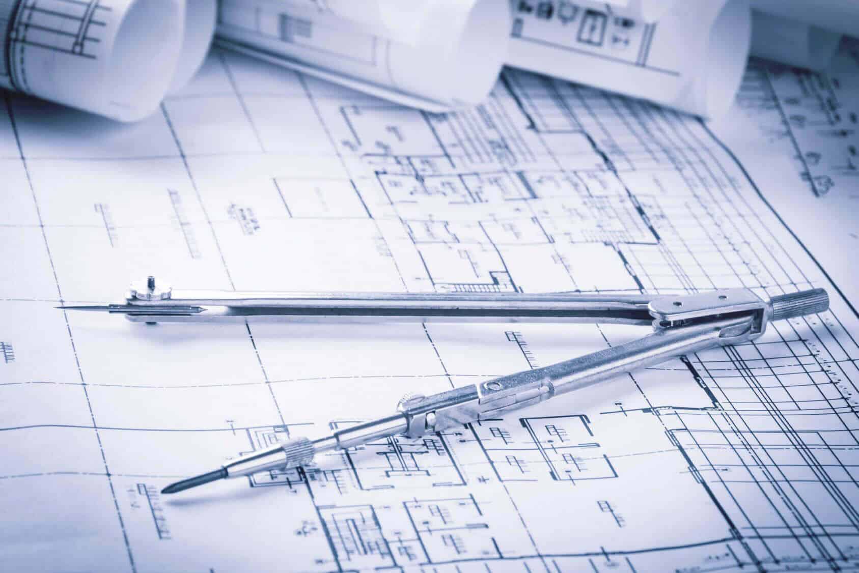 Picture of a compass over architectural sketches